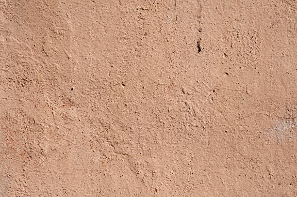 istock Texture of old wall covered with pink stucco 489436784