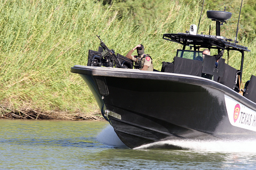 La Paloma, Texas, USA - September 22, 2015:  Members of the Texas Department of Public Safety's Highway Patrol unit monitor the Rio Grande River for illegal aliens crossing into the U.S.  Such encounters are a daily experience on the Rio Grande River.