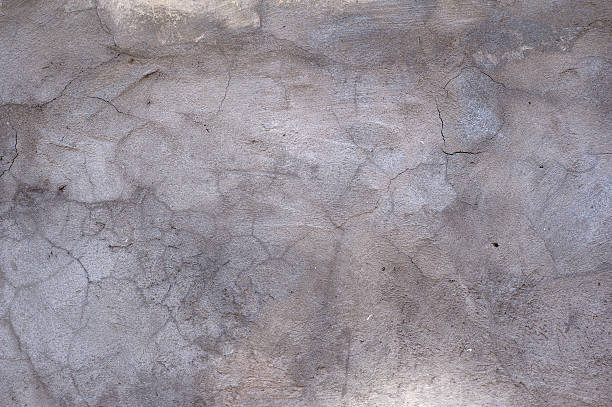 istock Texture of old wall covered with gray stucco 489437472