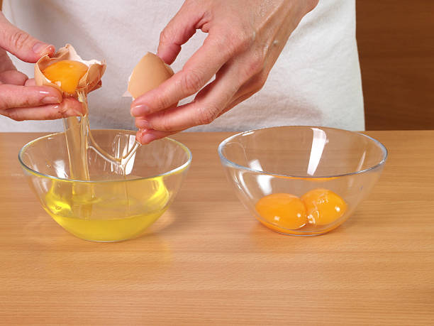 Separating egg yolk from white Separating egg yolk from white. Making Chocolate Layer Cake with Cream Cheese Filling and Chocolate Topping. Series. torte photos stock pictures, royalty-free photos & images