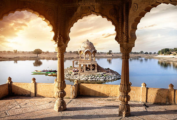Temple on the water in India Arches and temple in Gadi Sagar lake at sunset sky in Jaisalmer, Rajasthan, India palace photos stock pictures, royalty-free photos & images