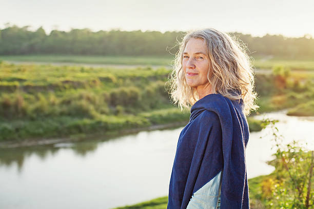 istock Old beautiful women on a shore of river 489478758