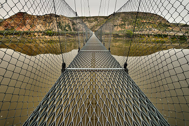 Suspension Bridge Landscape featuring the Star Mine Suspension Bridge from Drumheller, Alberta. drumheller valley stock pictures, royalty-free photos & images