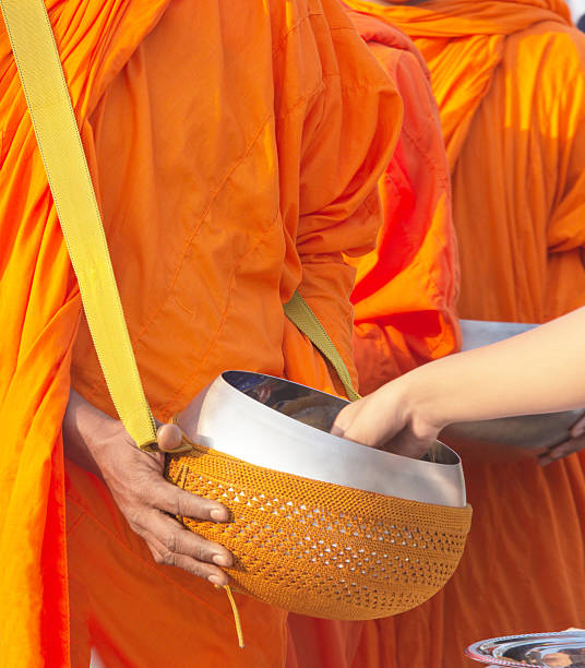 istock put food offerings in a Buddhist monk's alms bowl 489481043