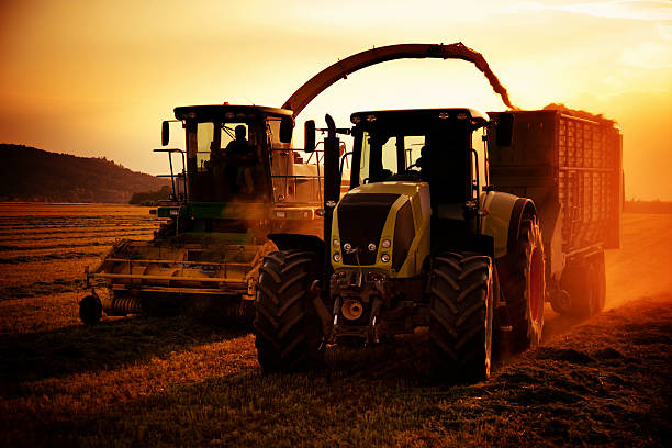 istock tractors working on farm field at sunset 489481441