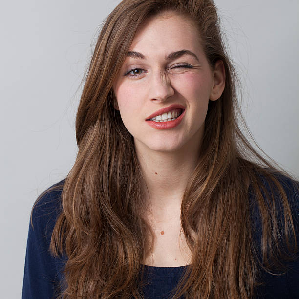 istock cool 20s brunette winking for success 489483502