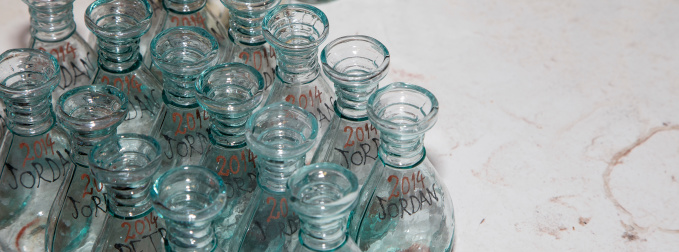 Sunlight filtering through colored glass bottles on a windowsill