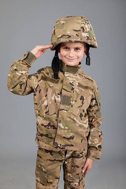 istock Saluting soldier. Young boy dressed like a soldier 489484491
