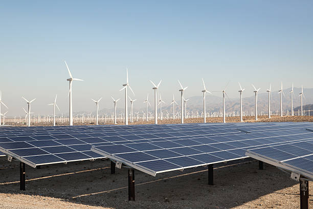 Renewable Solar Energy and Windmills Solar panels energy in a California desert. Sunlight, solar panels and wind turbines. Clear sky without could, image shows environmental conservation and alternative power generation methods. image created 21st century multi colored arrangement outdoors stock pictures, royalty-free photos & images