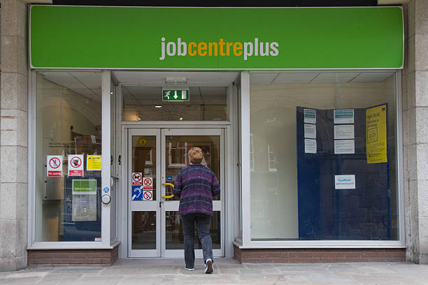 Looking for work. Shrewsbury, Shropshire, UK - May 5th 2014: Woman walks towards door of Job Centre Plus in Shrewsbury town center, Shropshire. unemployment stock pictures, royalty-free photos & images