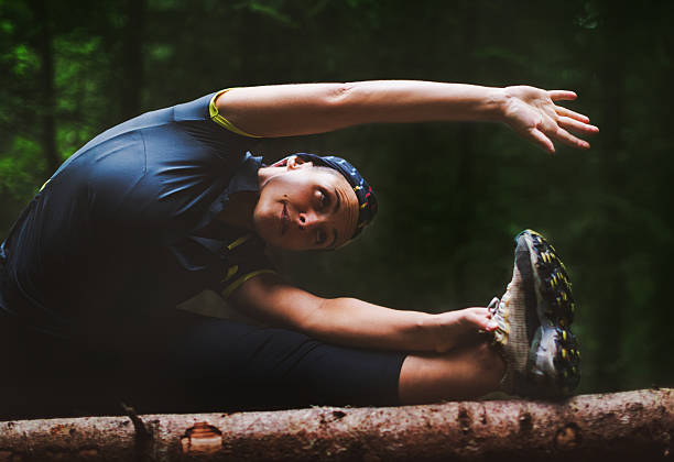 istock Woman athlete stretching in the forest after running 489485148
