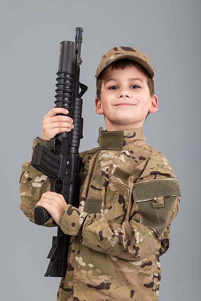 istock Young boy dressed like a soldier with rifle 489485453