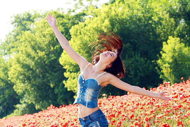 istock girl in poppies field 489486712