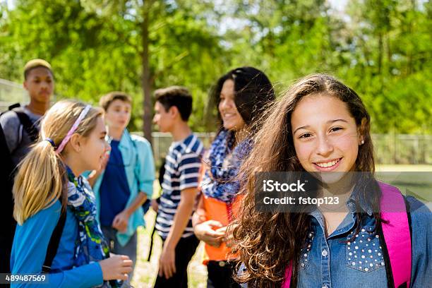 Education Latin Teenage Student With Friends At Local Park Stock Photo - Download Image Now