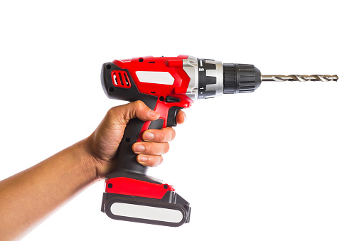 hand holds cordless drill isolated on white background