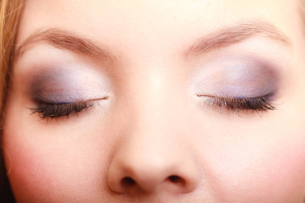 istock Closeup beautiful female eyes with make-up visage. 489488190