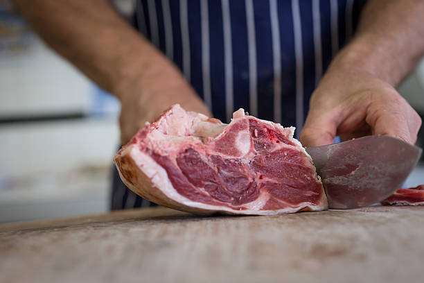 istock Close up of butcher cutting meat 489488502