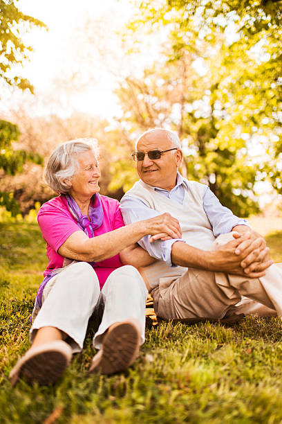 istock Smiling elderly couple relaxing in nature and communicating. 489488982