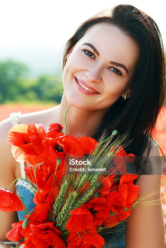 girl in poppies field young woman on the beautiful poppy field 2015 Stock Photo