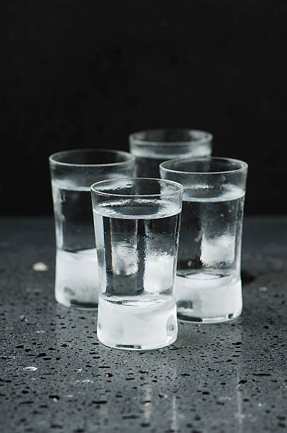 istock Glass of vodka on the black table 489492902