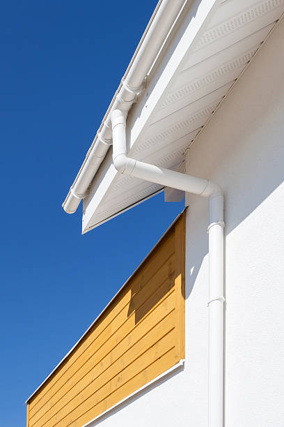 istock New rain gutter on a home with wooden panel a 489493104
