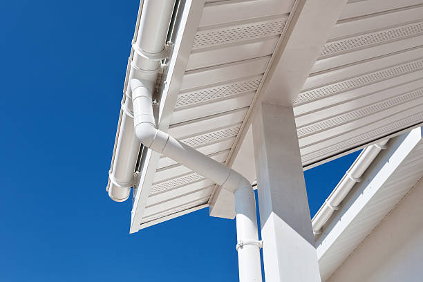 New rain gutter on a home against blue sky New rain gutter on a home against blue sky downspout stock pictures, royalty-free photos & images