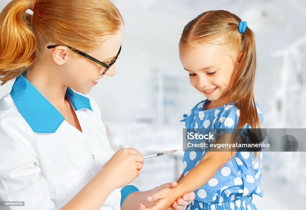 Doctor a pediatrician makes child vaccinated Doctor a pediatrician makes child vaccinated vaccination Child Stock Photo