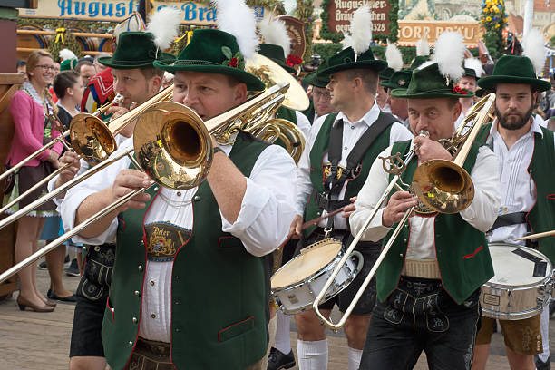 Munich, Germany – September 20, 2015: Traditional Marching Bands with Local Costumes entertain Crowds of visitors at the annual Oktoberfest. The Festival runs from September 19th until October 4th 2015 in Munich, Germany