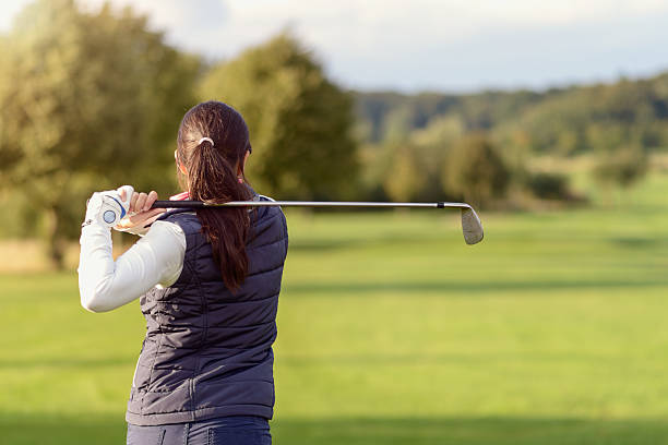 istock Female golfer striking the golf ball 489516738