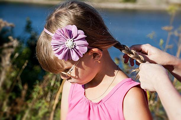 istock the little blonde girl whose mother braids 489518948
