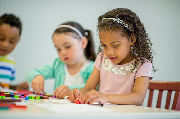 istock Little Girl Connecting Blocks 489519048