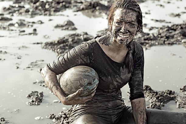 istock Young brunette female smiling during a mud run 489520958
