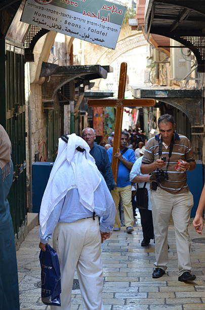 Mobile, Alabama, USA - April 19, 2019: A member of the St. Dominic Youth Group re-enacts the Stations of the Cross during a Good Friday procession in Cathedral Square in Mobile, Alabama.
