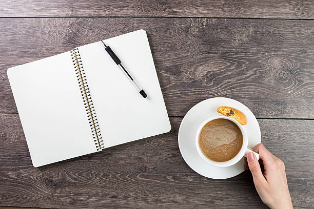 istock note pad and a cup of cappuccino. 489522502