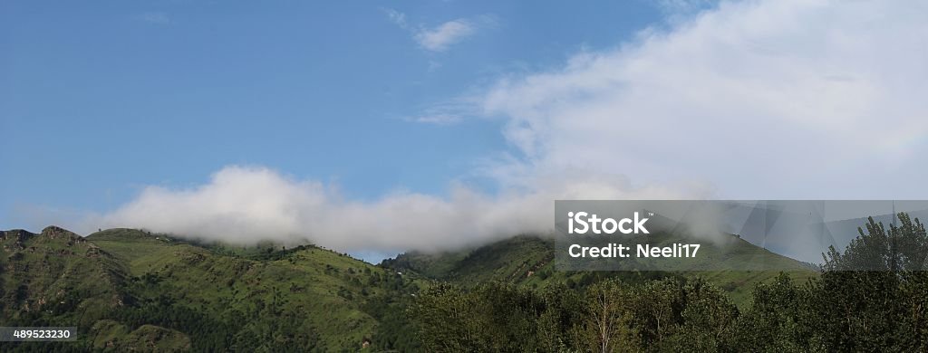 Cloud on the hills This cloud resting on the top of the hills of Abbottabad appeared after a sudden pour down. It was absolutely breathtaking! 2015 Stock Photo