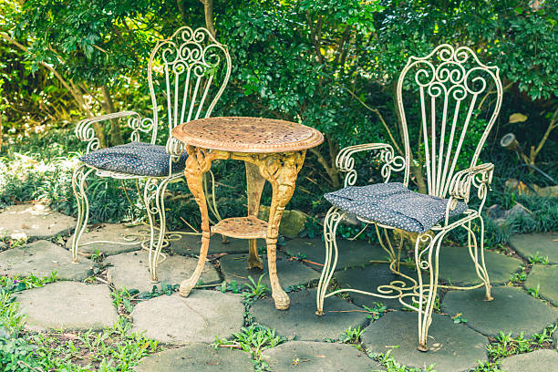 istock Vintage garden with white table and chairs 489524458