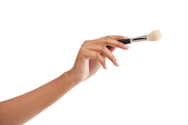 Cropped shot of a woman holding a makeup brush against a white backgroundhttp://195.154.178.81/DATA/i_collage/pi/shoots/805632.jpg