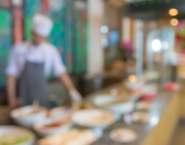 istock waiter or chef in uniform and food table  at restaurant 489529708