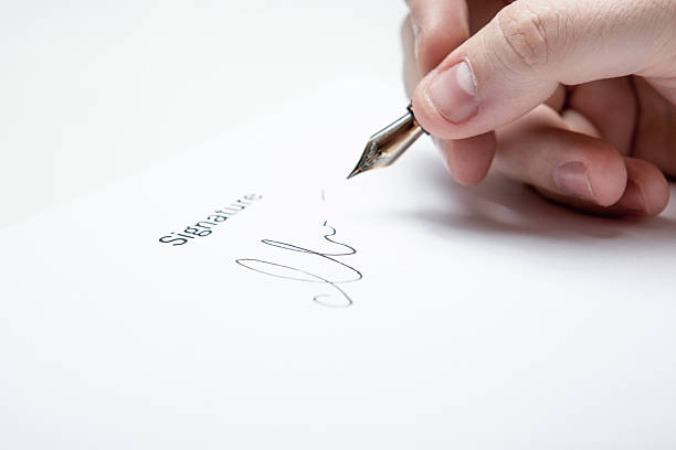 istock pen in the man's hand and signature 489543213