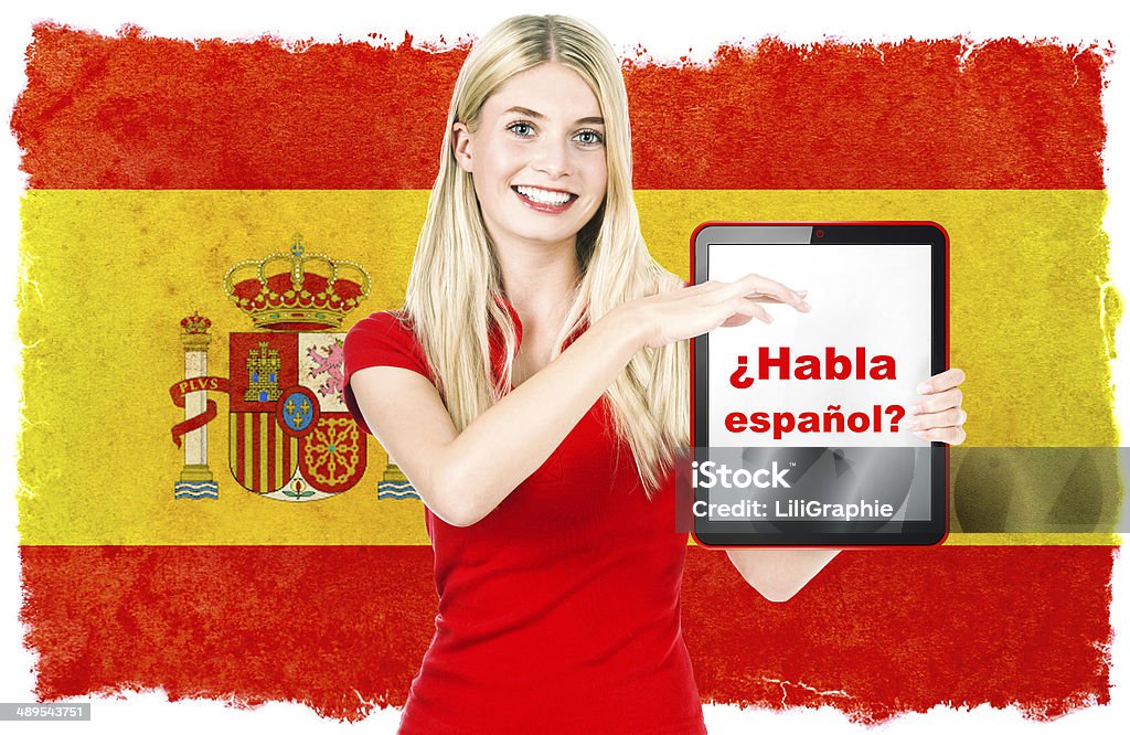 spanish language learning concept. Woman holding tablet PC Young woman holding tablet pc. National flag of Spain at the background. Spanish language learning concept. Collage. Clip-Art Adult Stock Photo