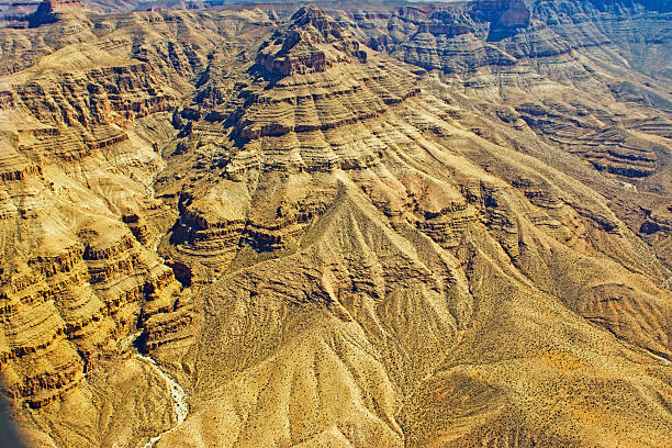 Weathered and eroded ravines and valleys showing dry river beds in the foothills south of the Grand Canyon and north of Lake Mead.