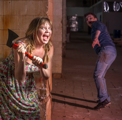 Scary woman with an ax in the pursuit of a man