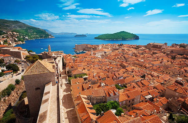 View of Dubrovnik, Croatia Old town of Dubrovnik with Lokrum island on background with red roofs dubrovnik walls stock pictures, royalty-free photos & images