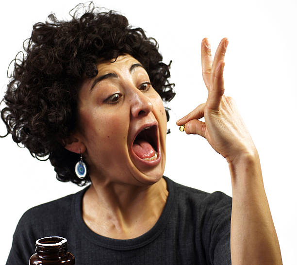 istock Woman swallows a pill 489547461