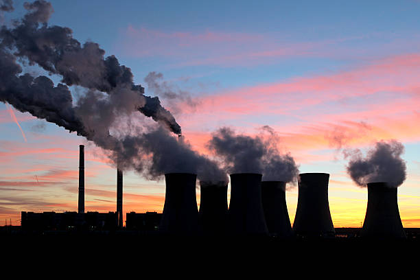 smoke from coal power plant under sunset sky stock photo