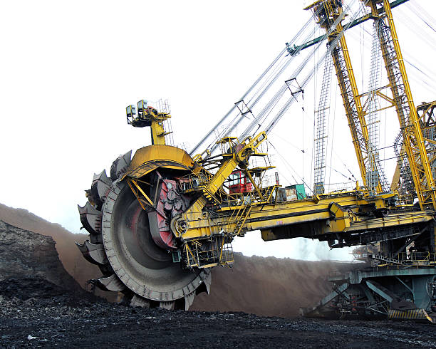 huge yellow  coal excavator in action stock photo
