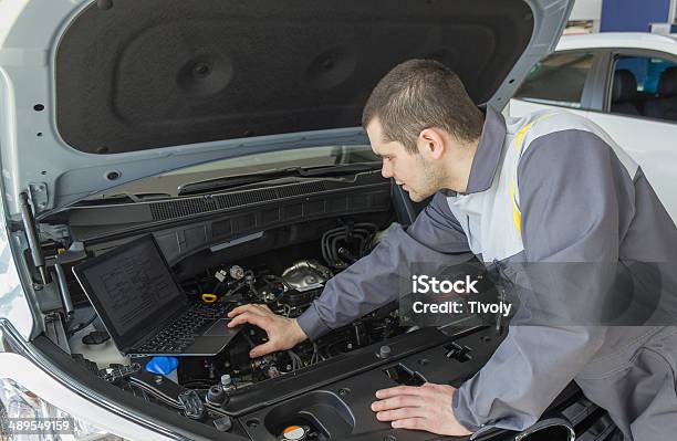 Car Mechanic With Laptop Stock Photo - Download Image Now - Adult, Adults Only, Blue-collar Worker