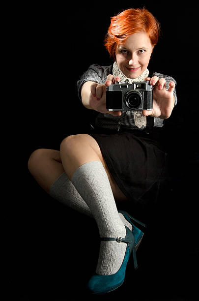 Young Woman Holding Old Camera