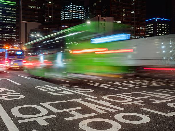 Traffic in the night at Seoul, South Korea Seoul, South Korea - September 15, 2014: Traffic in Seoul, South Korea, at night time which was shot in a slow shutter speed showing the traffic sign on the street. seoul bus stock pictures, royalty-free photos & images