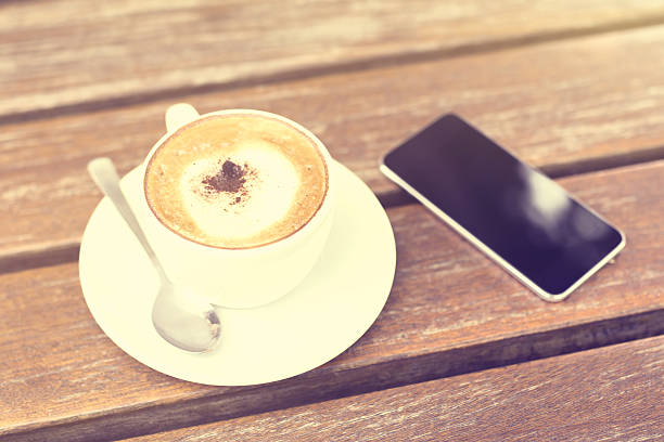 istock cell phone and cup of coffee on the table 489556326